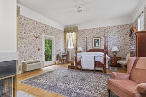 Bedroom with fireplace and patio