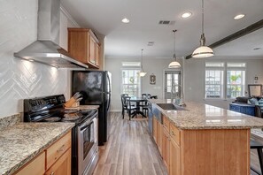 Spacious kitchen that looks into the living room
