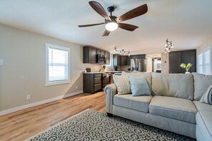 Open concept Livingroom with Roku tv, kitchen, and dining table 