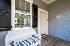 A covered front porch, sip your morning coffee on the wicker loveseat