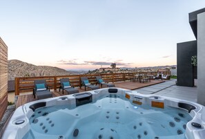 Relax in the hot tub while enjoying the sprawling desert view