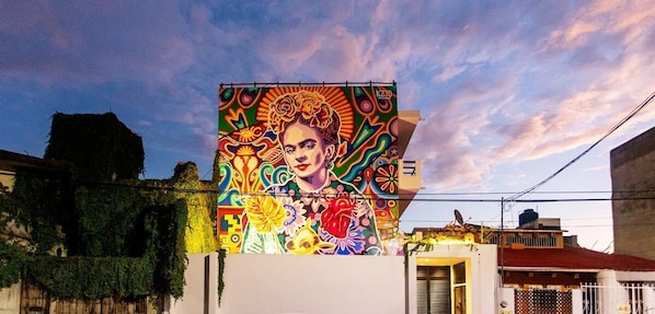 The street side of the building has a beautiful mural of Frida Kahlo