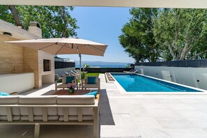 sun deck area next to the pool and on a rooftop terrace