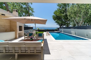 sun deck area next to the pool and on a rooftop terrace