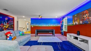 Game on! Stay in this epic Mario-themed game room with arcade vibes & fun!