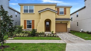 Beautiful modern home with stylish design, lush landscaping, and a welcoming entry!