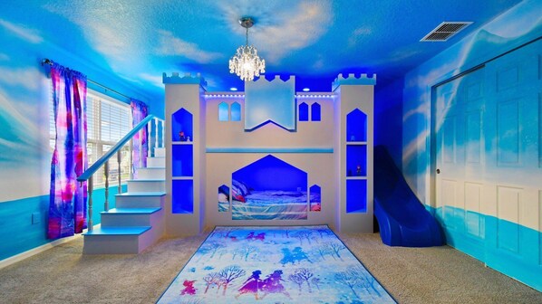 Stay in a magical, Frozen-inspired castle room with a slide, loft, and charm!