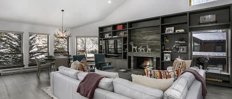 Grand Room with sectional couch, fireplace and flat screen TV