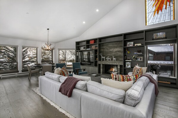 Grand Room with sectional couch, fireplace and flat screen TV