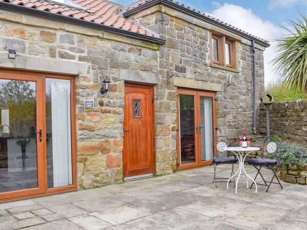 Enclosed patio with outside dining table and chairs