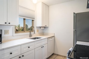 Bright kitchen overlooks another common area and parking