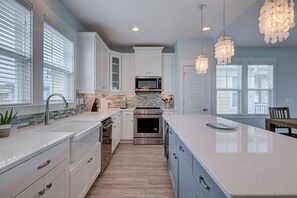 Custom high end light fixtures over kitchen island for great illumination. 