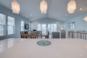 View of kitchen island out to 3rd floor balcony with ocean views.