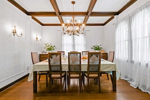 The formal dining room has original coffered ceilings with cornices and seating for 8.