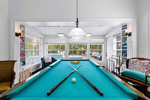 Game room with a pool table and Pac-Man Arcade machine for endless fun!
