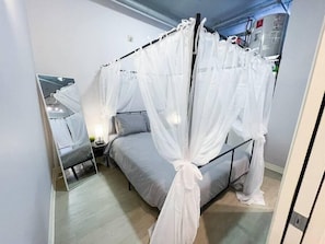 Queen-size canopy bed with sheer curtain sheets