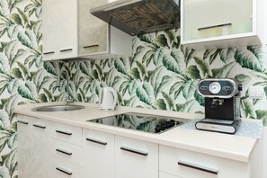 Fully equipped kitchenette with a kettle, electric cooker, fridge freezer, microwave oven and coffee machine.