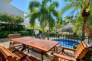 Outdoor dining area by the private pool.