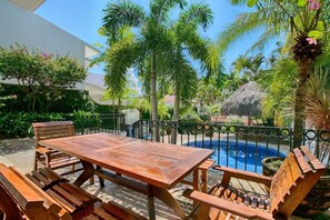 Outdoor dining area by the private pool.