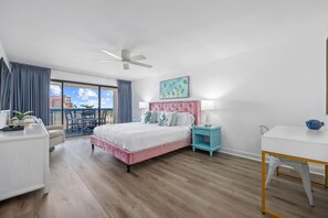 The primary bedroom is super fun with pink velvet bed with crisp white bedding