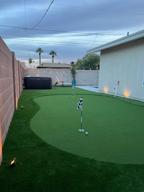 Freshly installed putting green and hot tub