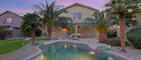 Private backyard with a sparkling blue pool!