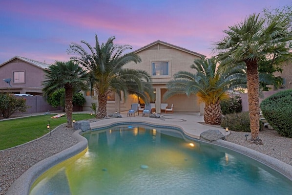 Private backyard with a sparkling blue pool!