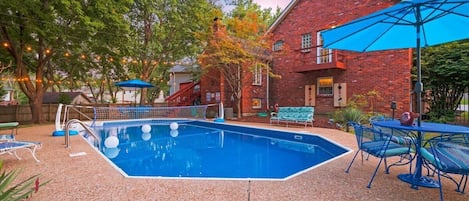 View of swimming pool and back of house at Sunset