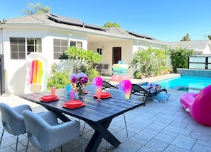 Outdoor sitting, dinging, and sun lounging areas by the pool.