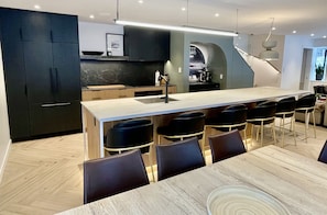 Entertainers kitchen & dining w/ 14 ft island & expandable dining table
