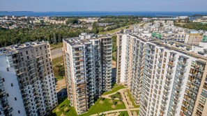 A high-rise view showcasing residential buildings, green spaces, and nearby city areas.