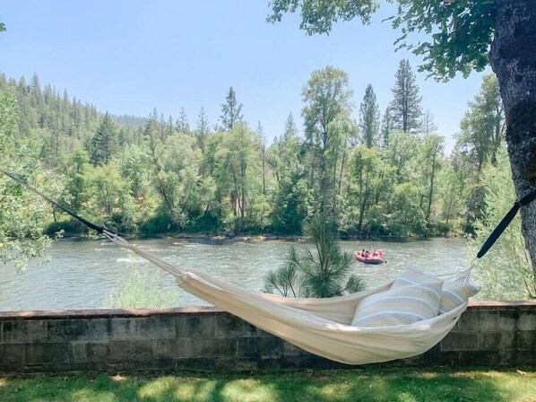 Relaxing in a hammock with breathtaking riverfront views on the Rogue River 