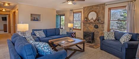 Cozy living area with ample seating, tv, and a gas stove