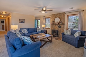Cozy living area with ample seating, tv, and a gas stove