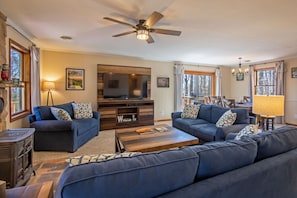 Cozy living area with ample seating, tv, and a gas stove