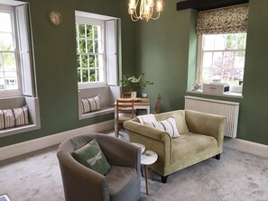 Living area with window seats overlooking river and park