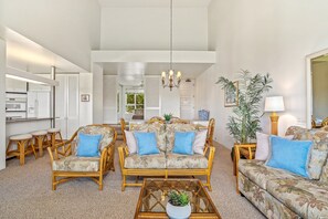 Open space living area with cathedral ceilings. 