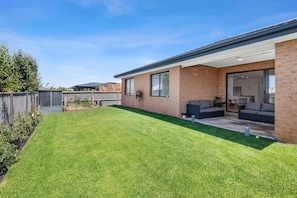 Outdoor entertaining area in a fully fenced backyard with lawn - pet friendly for a well-behaved pet, subject to approval at the time of booking.