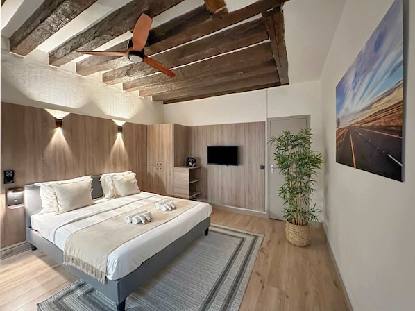 Queen-size bed with top quality mattress and ceiling fan