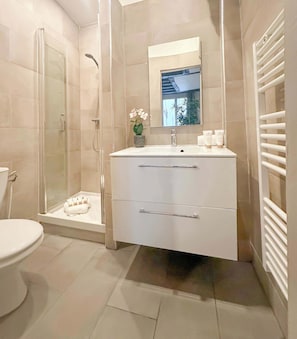A well equipped bathroom with shower