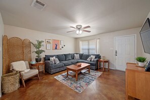 Living room with plenty of seating and a smart tv for movie nights