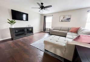 large living room area with 55" smart TV