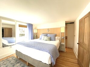 A king size bed with walk in closet area, bedside usb/elec hub & sound machine.