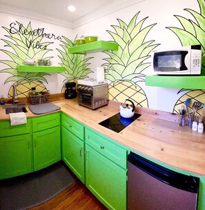 Funky groovy bright cheerful pineapple theme kitchen. Lots of stuff for cooking.