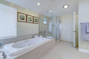 Master bath with luxury jetted tub, double sink, and shower.