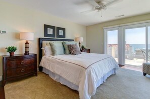 Master bedroom overlooking the ocean with balcony access.