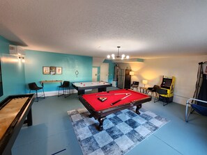 game room with pool table, air hockey, shuffleboard, darts, pop-a-shot, Pac-Man arcade, 75" LCD Roku Smart TV