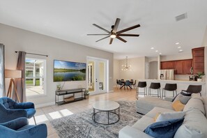 Bright, spacious living room with oversized fan