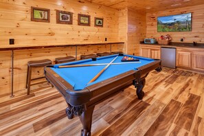 Pool table, drink ledge, bar and 55" smart TV.  Classic board games also.