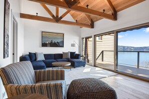 Open living space with lake view, TV, and fireplace